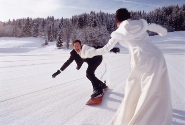 Broom and bride on snowboards