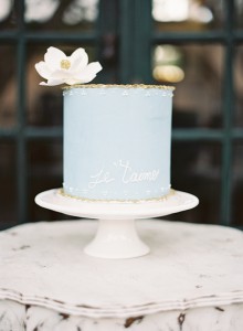 Pastel blue cake decorated with white flower