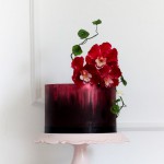 Red and black cake decorated with flowers
